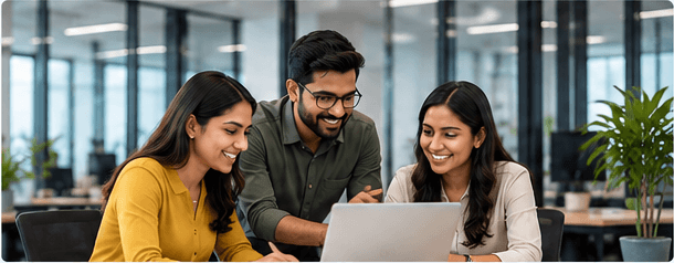 A diverse team discussing ideas around a laptop